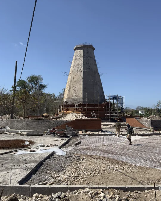 Menara meru yang tengah dibangun dikelilingi perancah di Catus Patha UNUD
